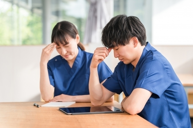 会議が長引いて悩んでいる介護職